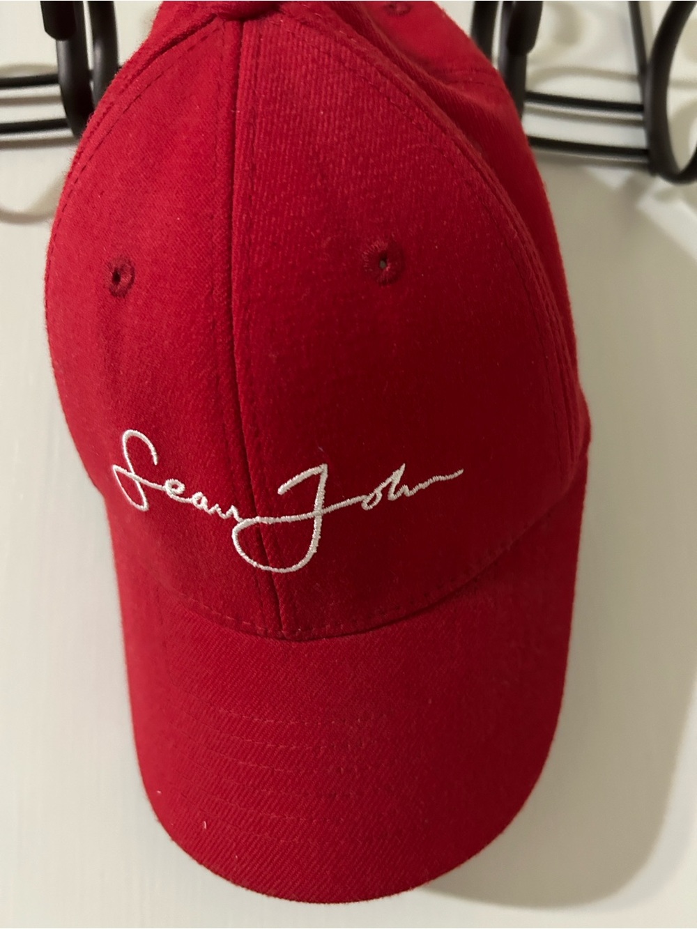 Classic Sean John Red Cap with White Script Embroidery name.